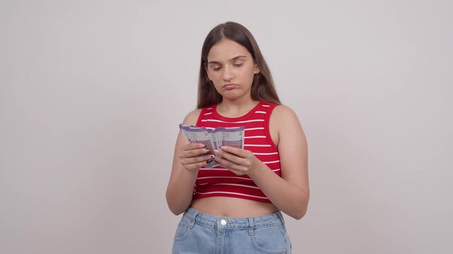 Confused Indian Teenage Girl Counting 100 Indian Rupee Notes
