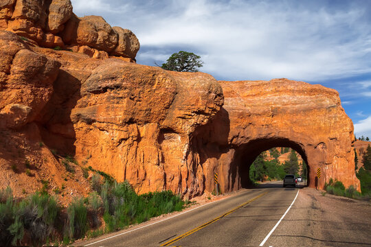 Cars driving through Red Canyon Arch Tunnel along Scenic Byway 12, Dixie National Forest, Utah, USA
