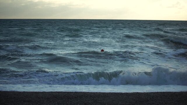 Ocean, Waves, Person - A lone person stands on a beach watching waves crash in the ocean.