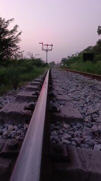 Railway track, junction and signal in green landscape