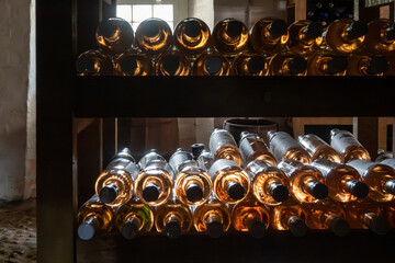 Obraz premium Gram, Denmark Old wine bottles in a wine rack in a cellar.