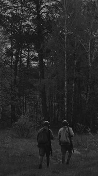 Two Soviet soldiers patrol the forest during World War II