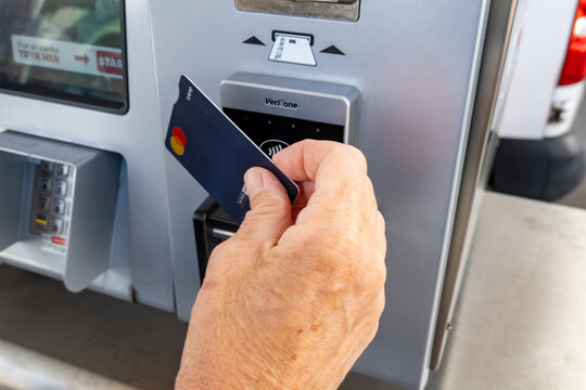 Nyborg, Denmark A woman uses a credit card to pay for gas at a gas station.