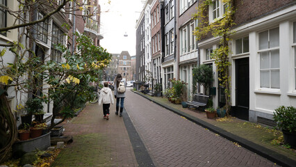 Obraz premium Mother and son walking on amsterdam street