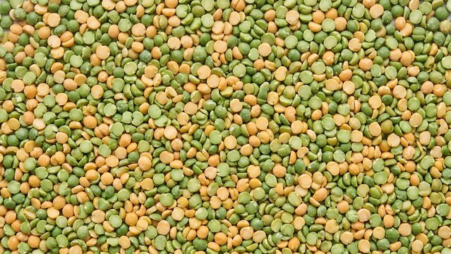 Close-up texture of dried split peas, a mix of green and yellow, for food and cooking concepts