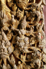 Naklejka premium Close-up of ancient Ayutthaya style wood carving depicting deity and mythical creatures on temple door at Wat Na Phra Meru, Ayutthaya, Thailand