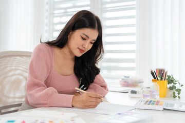 Female painter drawing with watercolor. hobby or leisure concept. © Fahng