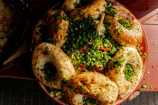 Top view of tandoor flatbreads on traditional pilaf platter