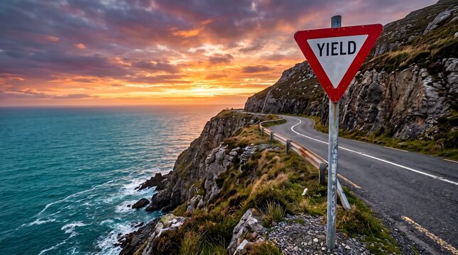 A scenic coastal road with a yield sign at sunset in Ireland.