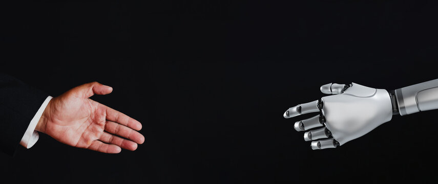 Businessman and robot reaching out for a handshake on a black background with copy space. Concept of artificial intelligence, future of work, human-machine interaction, and technology partnership.