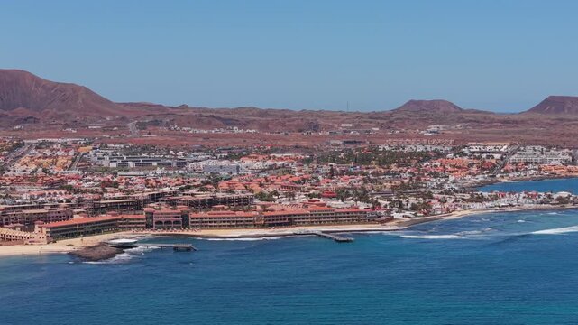 Aerial views of Corralejo town on the northeast coast of Fuerteventura, Canary Islands of Spain. It's known for Corralejo Natural Park, featuring windy, dune-backed beaches like Playa del Moro.