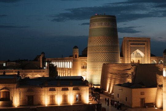Night view of illuminated Kalta Minor minaret and ancient city of Khiva, Uzbekistan