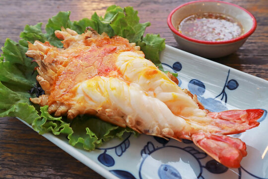 Grilled giant river prawn cut in half with creamy orange head tomalley served with dipping sauce, Thai food