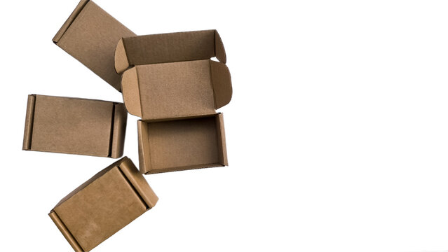 Arrangement of open craft cardboard tuck top boxes with ears on left border on isolated white background.