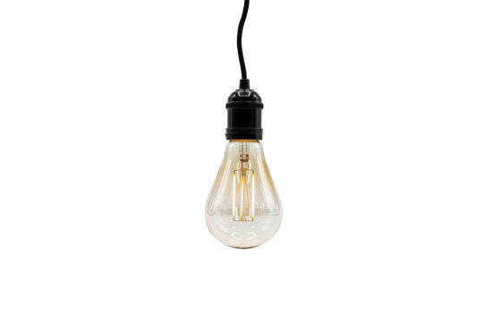 Vintage edison style light bulb with a black socket and hanging cord isolated on a transparent background
