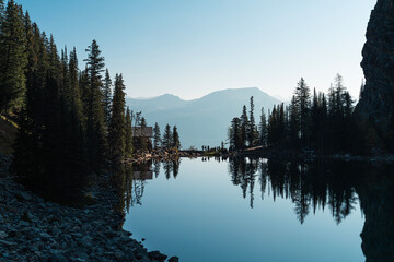 Coniferous trees reflected in Lake Agnes near Lake Agnes Tea House, Canada © Yutaka S.