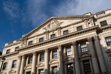 Fototapeta premium Elegant Classic Architecture With Corinthian Columns Under Clear Blue Sky