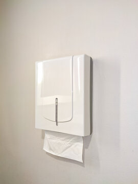 Minimalist white wall-mounted tissue box in a clean interior, offering practical hygiene access with a sleek design that blends seamlessly into modern bathroom or office spaces.