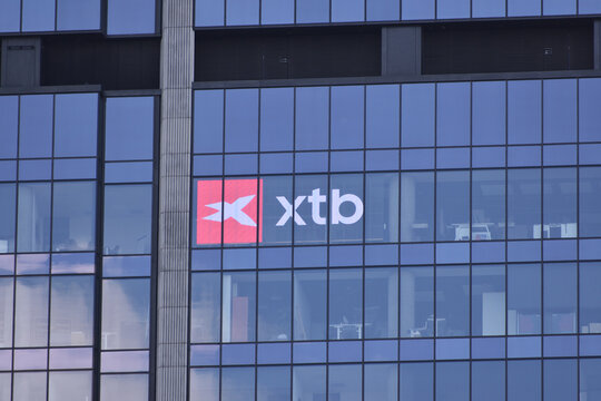 XTB company logo, signage, emblem on the facade. Polish trading platform, online broker, global leader in FX and CFD trading. WARSAW, POLAND - APRIL 25, 2026
