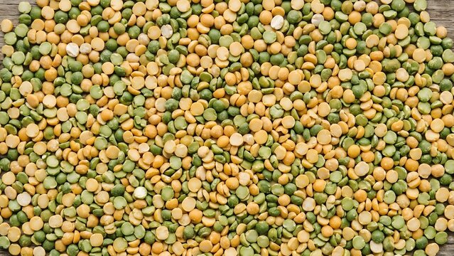 Close-up overhead view of dried split peas in yellow and green colors.