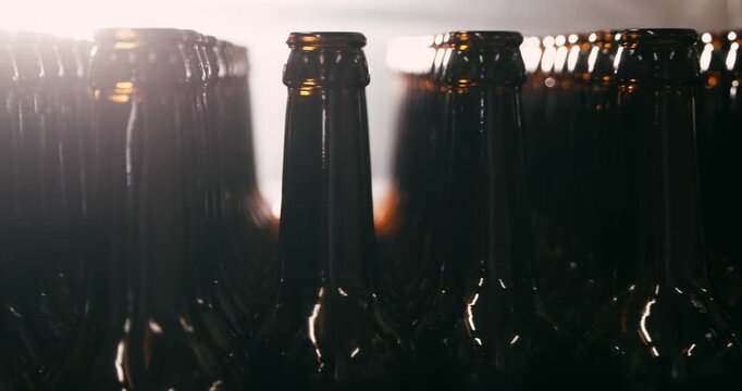 Unfilled beer bottles arranged in brewery camera circling around view