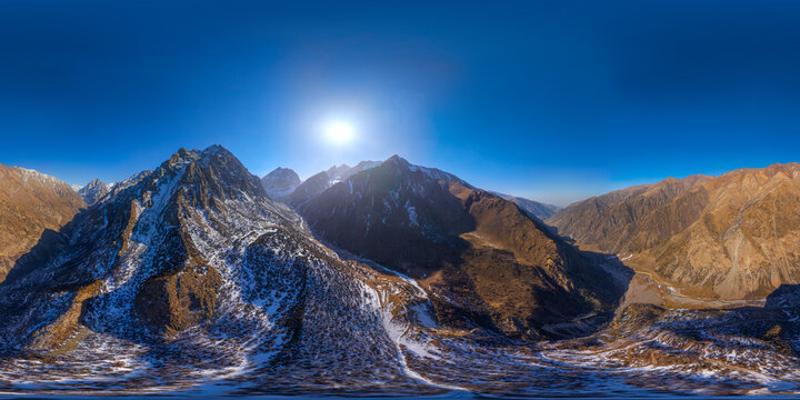 Dramatic Mountain Panorama in Kyrgyzstan with Snow and Sun