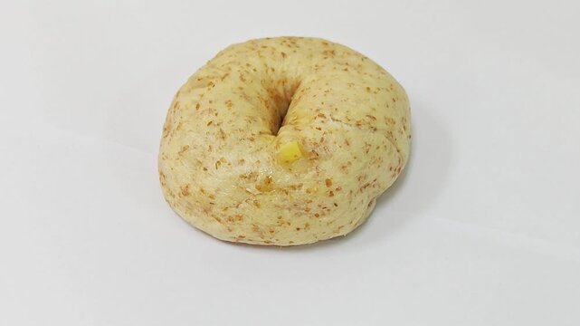 Whole wheat multigrain bagel isolated on white background.
