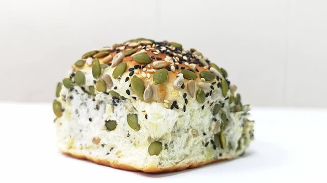 Multigrain seed bread bun isolated on white background.