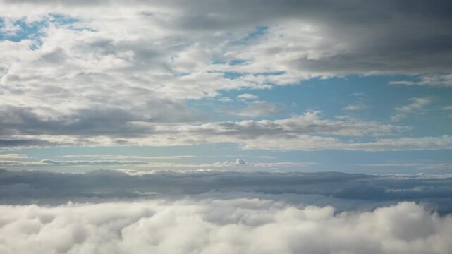 Layered clouds cover high altitude sky during flight. Meteorological atmospheric conditions create dense cloudscape over horizon. Clear weather front shows troposphere air mass changes.