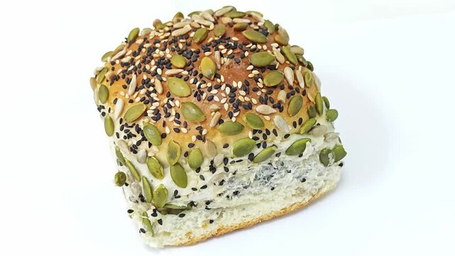 Healthy multigrain seed bread bun isolated on white background.