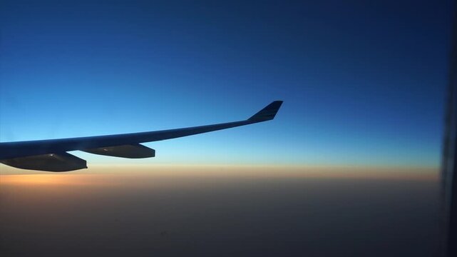Airplane Wing In Sky Daylight Flight View From Passenger Window Travel Concept Aviation Jet Commercial Plane High Altitude Clear Horizon Scenic Background Journey Transportation Serene