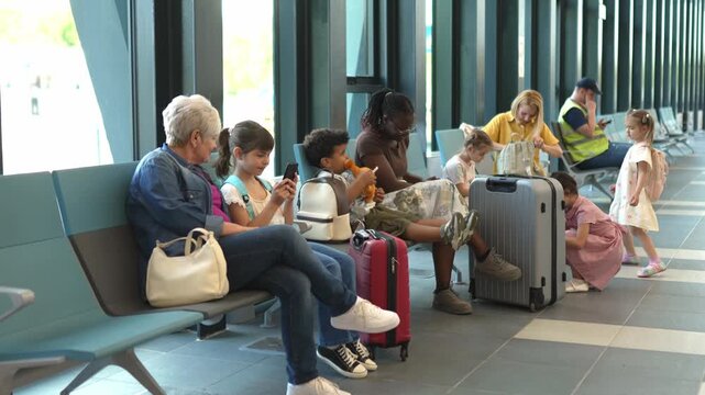 Diverse group of people in an airport waiting for boarding