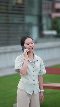 Joyful businesswoman talking on the phone outdoors