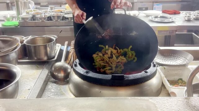Hands Cooking Noodles and Vegetables in Wok &ndash; Chinese Restaurant Kitchen