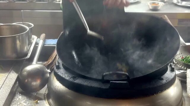 Hands Cooking Noodles and Vegetables in Wok &ndash; Chinese Restaurant Kitchen