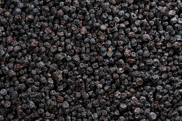 Full frame texture of dried organic blueberries background. Top view closeup of large pile of dark dried blueberries creating detailed natural berry texture pattern © OlegD