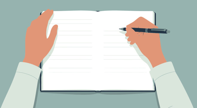 Hand writing in open notebook with pen from above view