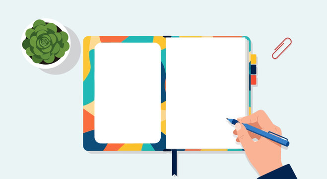 Hand writing in open notebook with plant and paperclip flat lay