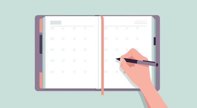 Hand writing in open planner calendar page planning schedule