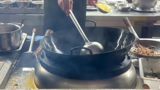 Hands Cooking Noodles and Vegetables in Wok &ndash; Chinese Restaurant Kitchen