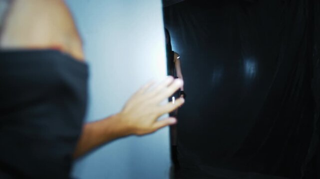 Man opening a container discovering a futuristic female android, a concept for human trafficking