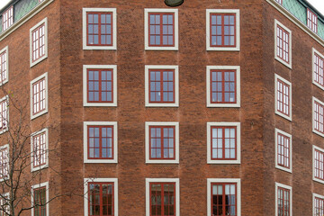 Fototapeta premium Copenhagen brick building facade with red windows
