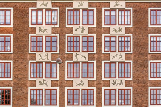 Copenhagen brick building facade featuring mythological reliefs