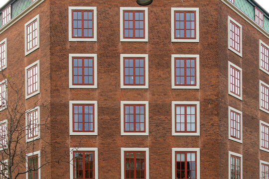 Copenhagen brick building facade with red windows