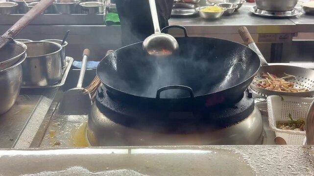 Hands Cooking Noodles and Vegetables in Wok &ndash; Chinese Restaurant Kitchen