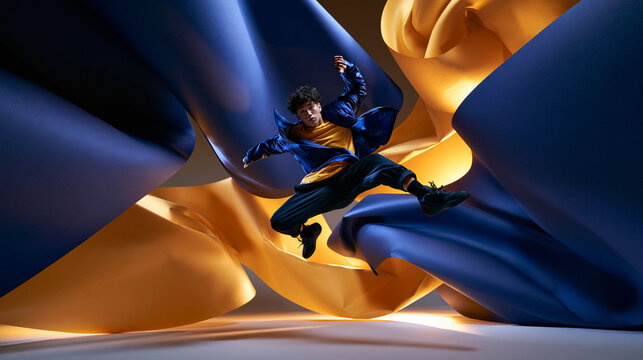 Dynamic Young Male Dancer Jumping Mid Air in Studio