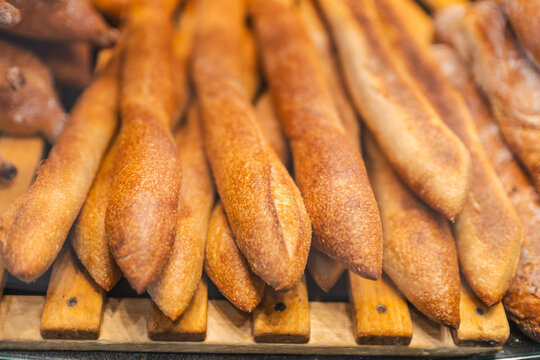 Golden Brown Baguettes on Wooden Bakery Rack