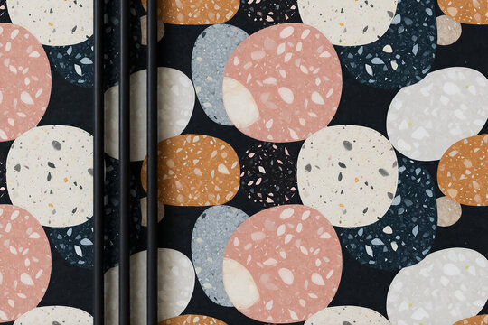 An abstract terrazzo pattern with organic pebble shapes in pastel and earth tones is capped by three pipes.