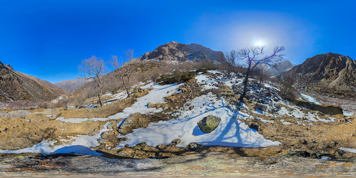 Mountainous Landscape in Kyrgyzstan with Snow and Bare Trees