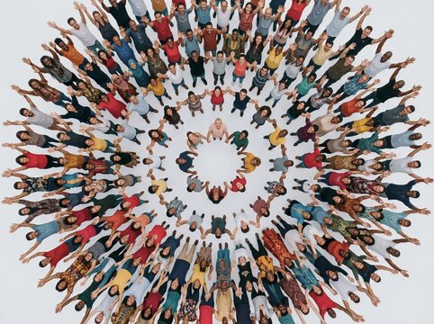 Close up of diverse people standing in a circle with raised arms, smiling in unity